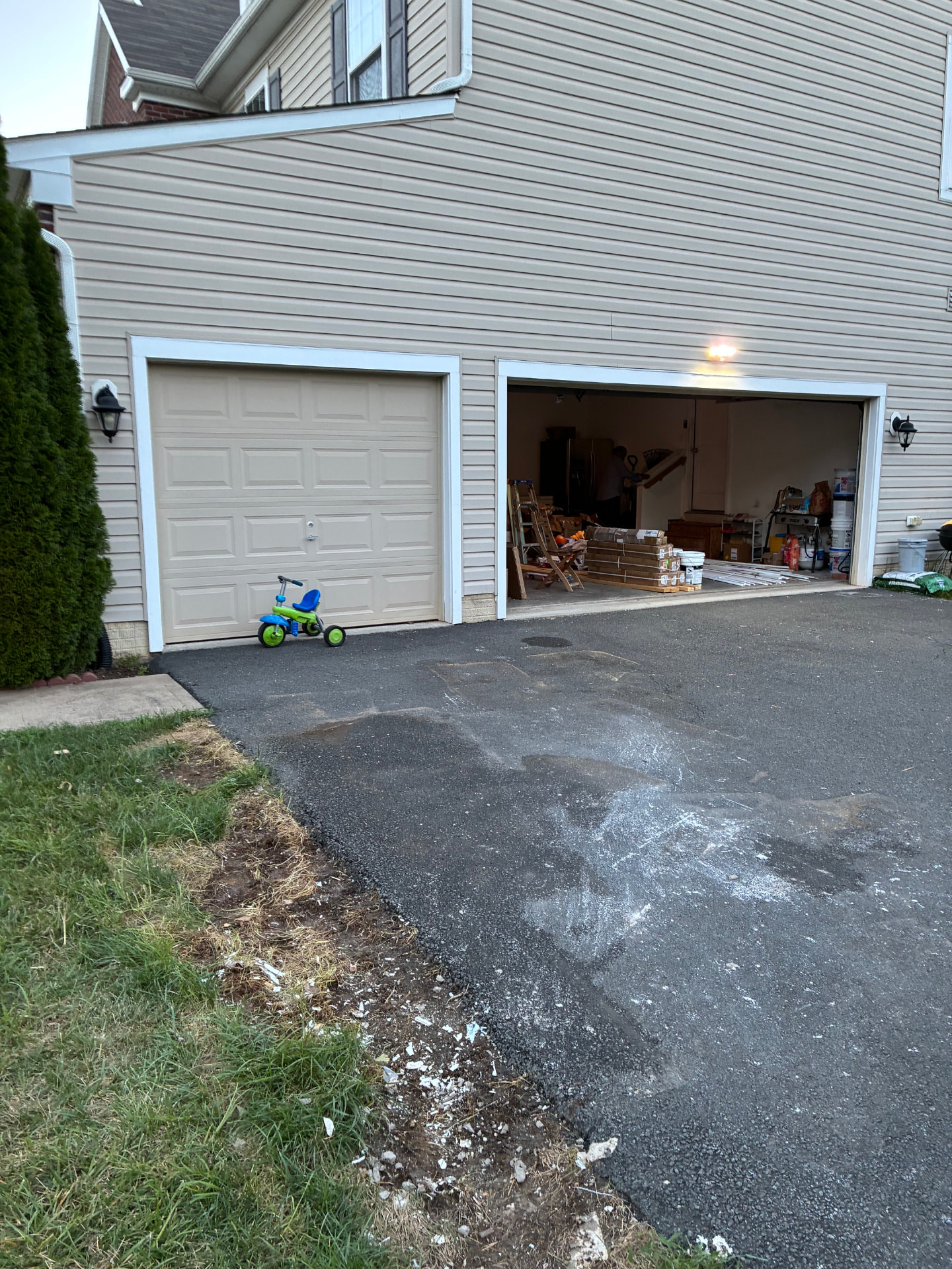 Clean driveway and open garage after the debris was hauled away and swept