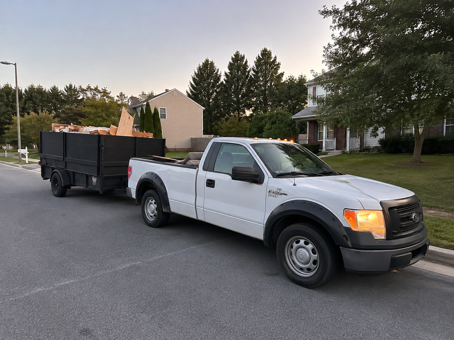 Pro Lift Junk Removal team loading a sofa into a branded truck in Aldie, Virginia
